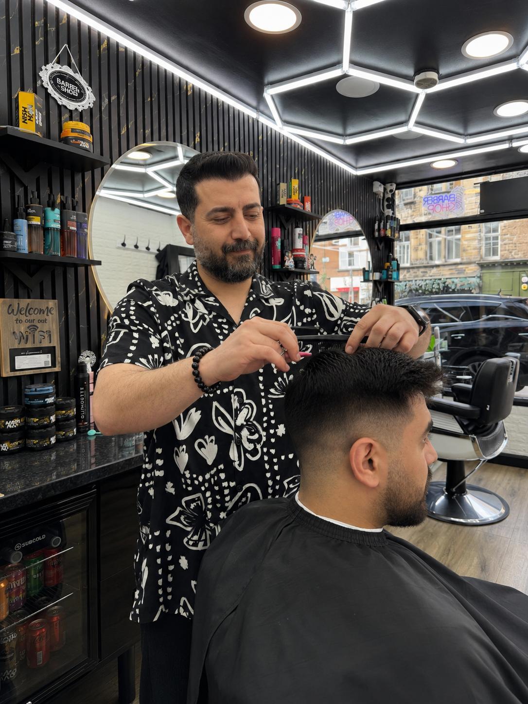 Mehmet cutting a gent's hair at Red Hair Salon